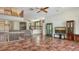Open living room with terracotta tile, a staircase, and an entertainment center at 222 Beach Rd # 7, Sarasota, FL 34242