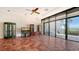 Living room with terra cotta tile, ceiling fan, and large sliding doors to a beachfront view at 222 Beach Rd # 7, Sarasota, FL 34242