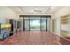 Spacious living room with beachfront views through expansive sliding glass doors and built-in bookshelves at 222 Beach Rd # 7, Sarasota, FL 34242