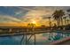 Beautiful community pool with lounge chairs and a sunset view of the beach at this tranquil waterfront property at 222 Beach Rd # 7, Sarasota, FL 34242