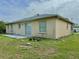 Rear exterior of the home showing a modest patio and well-kept backyard at 2403 Trianna St, North Port, FL 34291