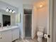 Bathroom featuring a vanity sink, mirror, and a glass-enclosed shower stall at 2403 Trianna St, North Port, FL 34291