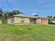A single-story home with a well-kept lawn, with chain link fencing in the background at 2403 Trianna St, North Port, FL 34291