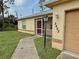 Close-up of a home's front entrance, featuring a well-lit doorway and maintained lawn at 2403 Trianna St, North Port, FL 34291