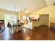 Open concept dining and kitchen with stainless steel appliances and wood laminate flooring at 2403 Trianna St, North Port, FL 34291