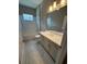 Well-lit bathroom with a vanity, toilet and shower-tub, creating a comfortable and functional space at 24827 Buckingham Way, Port Charlotte, FL 33980
