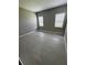 Cozy bedroom featuring large windows and tile floors that bring warmth to the space at 24827 Buckingham Way, Port Charlotte, FL 33980