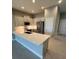 Modern kitchen with white cabinets, stainless steel appliances, and a spacious countertop at 24827 Buckingham Way, Port Charlotte, FL 33980