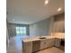 Bright kitchen featuring an island, stainless steel appliances, and a view of the backyard at 24827 Buckingham Way, Port Charlotte, FL 33980