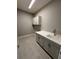 Functional laundry room featuring grey cabinets, white countertops, and a sink for added convenience at 24827 Buckingham Way, Port Charlotte, FL 33980