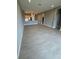 Open-concept living area with tile flooring that seamlessly connects to the kitchen at 24827 Buckingham Way, Port Charlotte, FL 33980