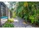 Lush backyard featuring tropical foliage and a glimpse of the pool, creating a serene outdoor escape at 2515 Huntington Ave, Sarasota, FL 34232