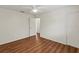 An empty bedroom showcasing wood-look flooring and a modern ceiling fan, awaiting personalization and decor at 2515 Huntington Ave, Sarasota, FL 34232