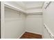 Walk-in closet with laminate flooring and rods for hanging clothes at 2515 Huntington Ave, Sarasota, FL 34232