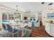 Bright dining area with stylish furniture that flows into the living room with pool views at 2515 Huntington Ave, Sarasota, FL 34232
