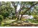A charming single-story home with lush trees shading the lawn at 2515 Huntington Ave, Sarasota, FL 34232