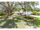Well-kept one-story home with a two-car garage and shaded by mature trees at 2515 Huntington Ave, Sarasota, FL 34232