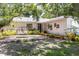 Home's front yard offers a decorative bench and well-maintained landscaping at 2515 Huntington Ave, Sarasota, FL 34232