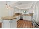 Well-lit kitchen featuring white cabinets, an island, and stainless steel appliances at 2515 Huntington Ave, Sarasota, FL 34232