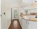 Bright kitchen with white cabinets, granite countertops, and wood floors throughout at 2515 Huntington Ave, Sarasota, FL 34232