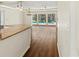 Open-concept living space with wood flooring and views of the outdoor pool area at 2515 Huntington Ave, Sarasota, FL 34232