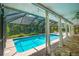 A screened-in pool surrounded by elegant white drapes and lush tropical foliage, creating a private oasis at 2515 Huntington Ave, Sarasota, FL 34232