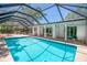 A refreshing screened-in pool with clear blue water and a spacious deck, perfect for outdoor relaxation at 2515 Huntington Ave, Sarasota, FL 34232