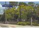 The Legacy Trail sign hanging above a street surrounded by lush landscaping and trees at 2515 Huntington Ave, Sarasota, FL 34232