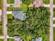 Stunning aerial view of property with a pool nestled among tropical foliage in a quiet neighborhood at 2546 Malibu Ln, North Port, FL 34286