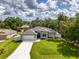 Lovely aerial shot of a bright home with nice landscaping, a grey roof and a manicured front yard at 2546 Malibu Ln, North Port, FL 34286