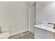 A bathroom with gray flooring, sink, and toilet at 2546 Malibu Ln, North Port, FL 34286