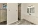 Bright bathroom showcases tile shower, sleek cabinets, marble counters, modern light fixture, and wood floors at 2546 Malibu Ln, North Port, FL 34286