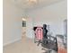 This carpeted bedroom includes a ceiling fan and a doorway to an adjoining room at 2546 Malibu Ln, North Port, FL 34286