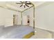 Spacious bedroom boasts a tray ceiling, stylish ceiling fan, and a sleek four-poster bed frame at 2546 Malibu Ln, North Port, FL 34286