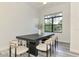 Light and airy dining room with a large table, modern chairs, and a scenic window at 2546 Malibu Ln, North Port, FL 34286