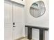Modern entryway boasts a striking mirror and console table, complemented by double doors at 2546 Malibu Ln, North Port, FL 34286