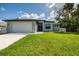 Charming single-story home with a manicured lawn, a two-car garage, and fresh modern landscaping at 2546 Malibu Ln, North Port, FL 34286