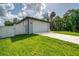 Bright two-car garage with a white door and an extra wide driveway at 2546 Malibu Ln, North Port, FL 34286