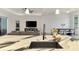 Modern kitchen featuring marble countertops, an island with a sink, and an open view to the living room at 2546 Malibu Ln, North Port, FL 34286