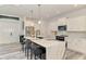 Kitchen featuring marble island with bar seating, stainless steel appliances, and modern pendant lighting at 2546 Malibu Ln, North Port, FL 34286
