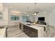 Modern kitchen island with sleek countertops and cabinetry, opening to the living area at 2546 Malibu Ln, North Port, FL 34286