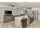 Modern kitchen featuring a large marble island, stainless steel appliances and open floor plan at 2546 Malibu Ln, North Port, FL 34286
