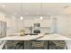 Modern kitchen features marble countertops and island with bar seating at 2546 Malibu Ln, North Port, FL 34286