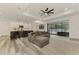 Bright living room with modern kitchen, comfortable seating, and sliding glass doors to the outdoor space at 2546 Malibu Ln, North Port, FL 34286