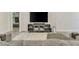Cozy living room features a large flat screen tv, comfortable seating and natural light at 2546 Malibu Ln, North Port, FL 34286