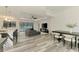 Open-concept living space featuring a kitchen island, comfortable seating, and dining area at 2546 Malibu Ln, North Port, FL 34286