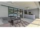 The screened patio features outdoor seating, a ceiling fan, and a grilling area at 2546 Malibu Ln, North Port, FL 34286