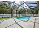 Beautiful backyard pool surrounded by a screened enclosure and lush landscaping at 2546 Malibu Ln, North Port, FL 34286