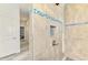 Tiled walk-in shower features a modern shower head, built-in niche, and blue tile accents at 2546 Malibu Ln, North Port, FL 34286