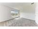 Bright bedroom with neutral carpet, two windows, and ample natural light at 317 Via Tuscany Ave, Sarasota, FL 34243